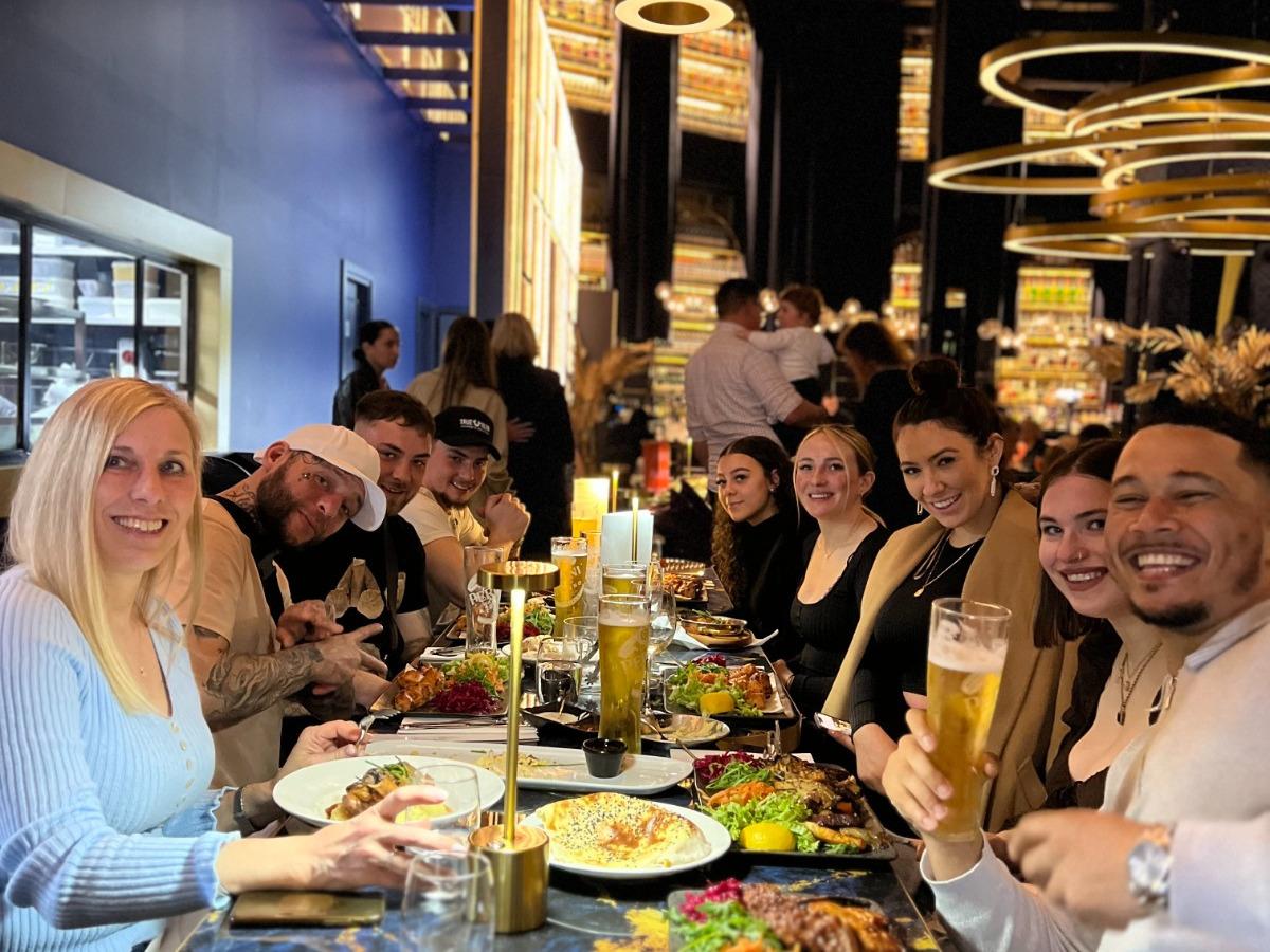 Guests enjoying a meal together at Opuz Aylesbury